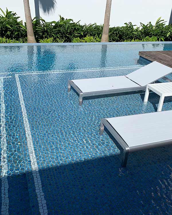 image of blue tile lounging swimming pool by Poseidon Pools Hawaii
