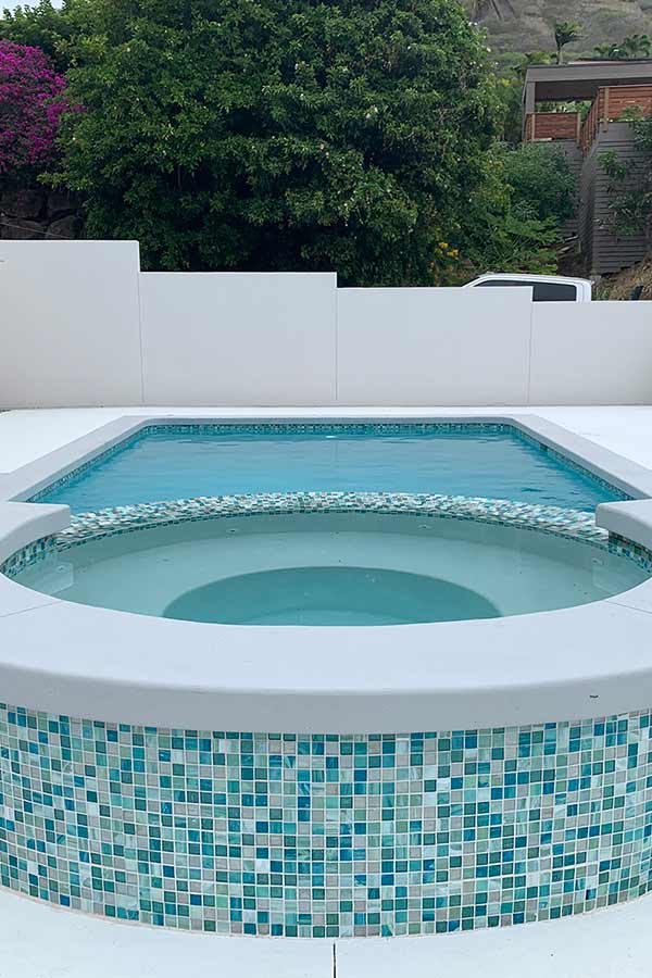 image of swimming pool with hot tub integration by Poseidon Pools Hawaii