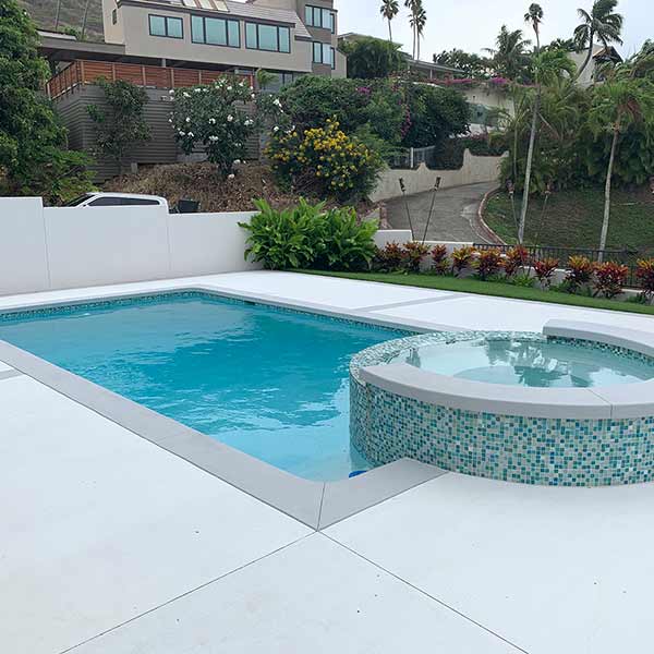 image of swimming pool with hot tub integration by Poseidon Pools Hawaii