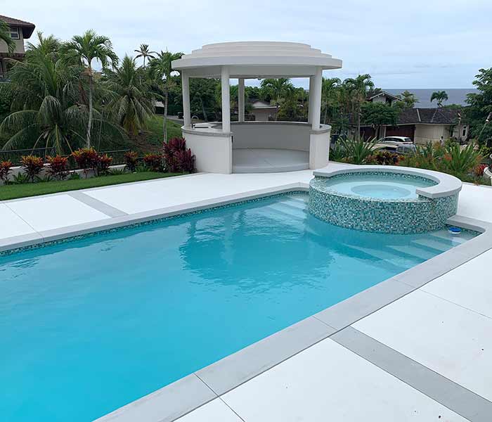 image of swimming pool with hot tub integration by Poseidon Pools Hawaii